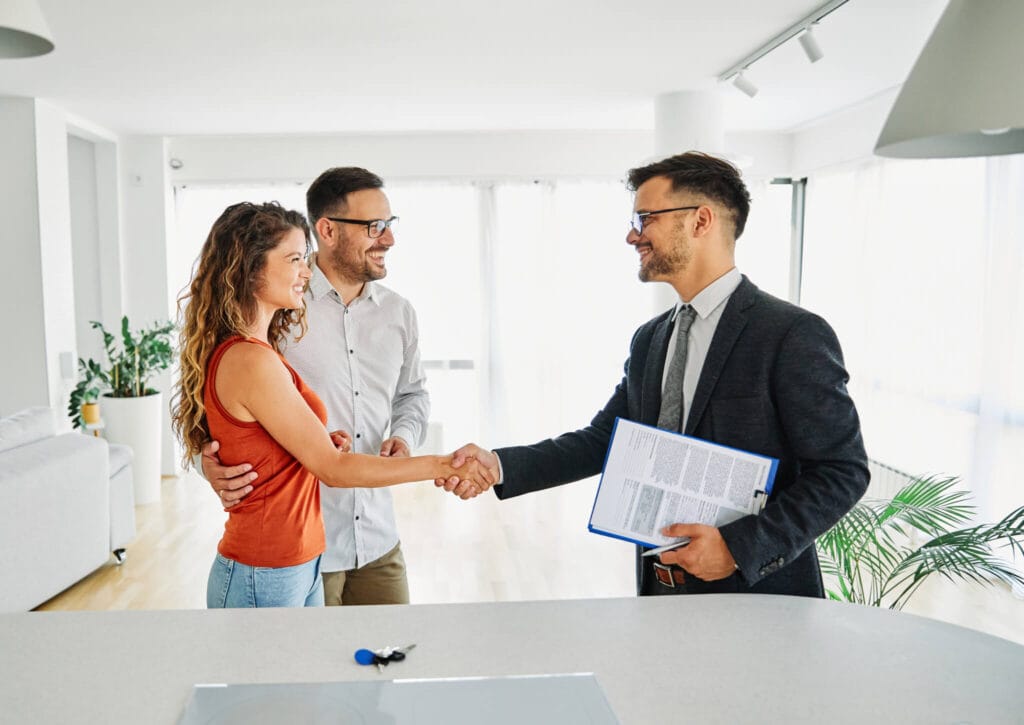 A couple women handshake with men